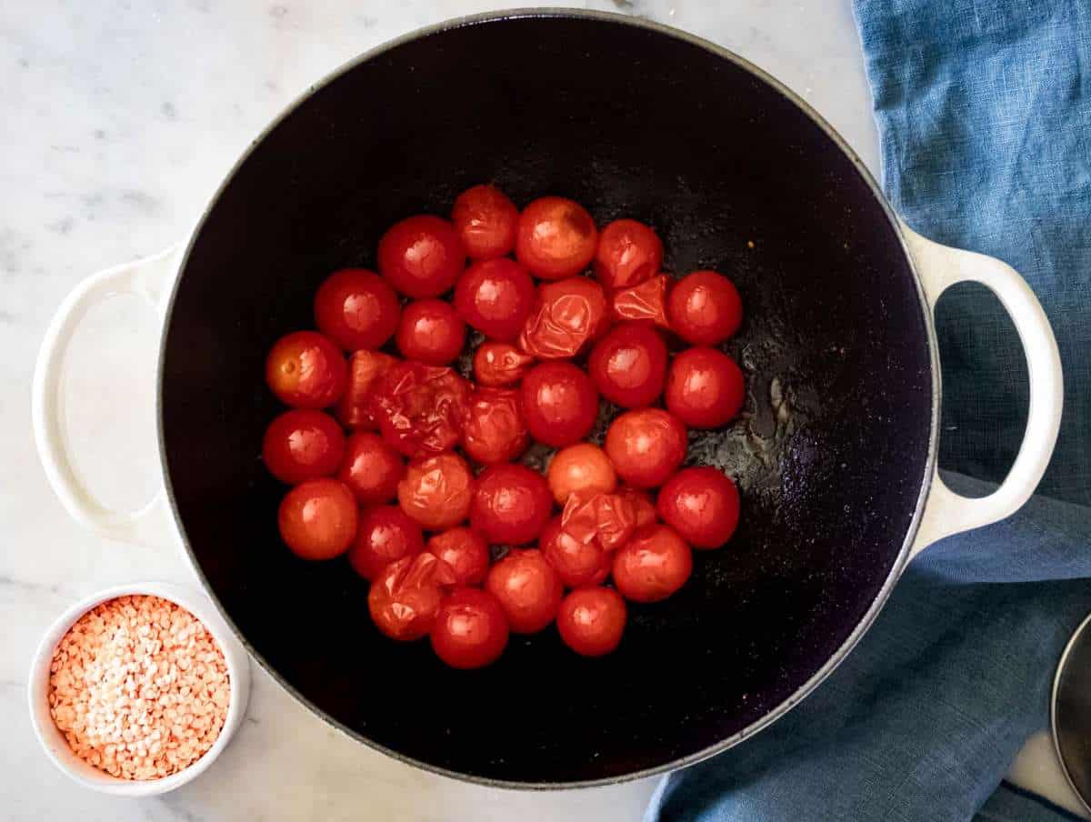 Step 1 Blistering cherry tomatoes in olive oil in a Dutch oven.