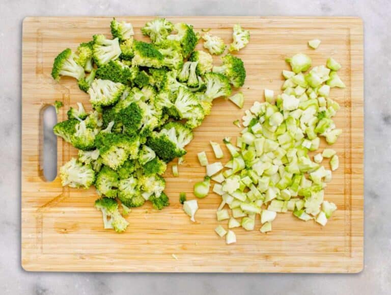 Step 1 Chopped broccoli florets and stems on a cutting board ready for salad.