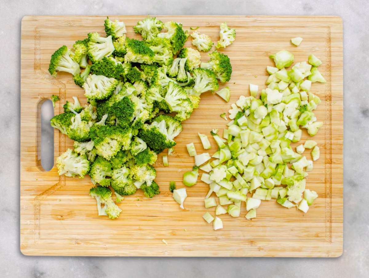 Step 1 Chopped broccoli florets and stems on a cutting board ready for salad.