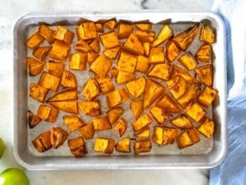 Step 1 Diced sweet potatoes on baking sheet roasted with olive oil, salt, and black pepper.