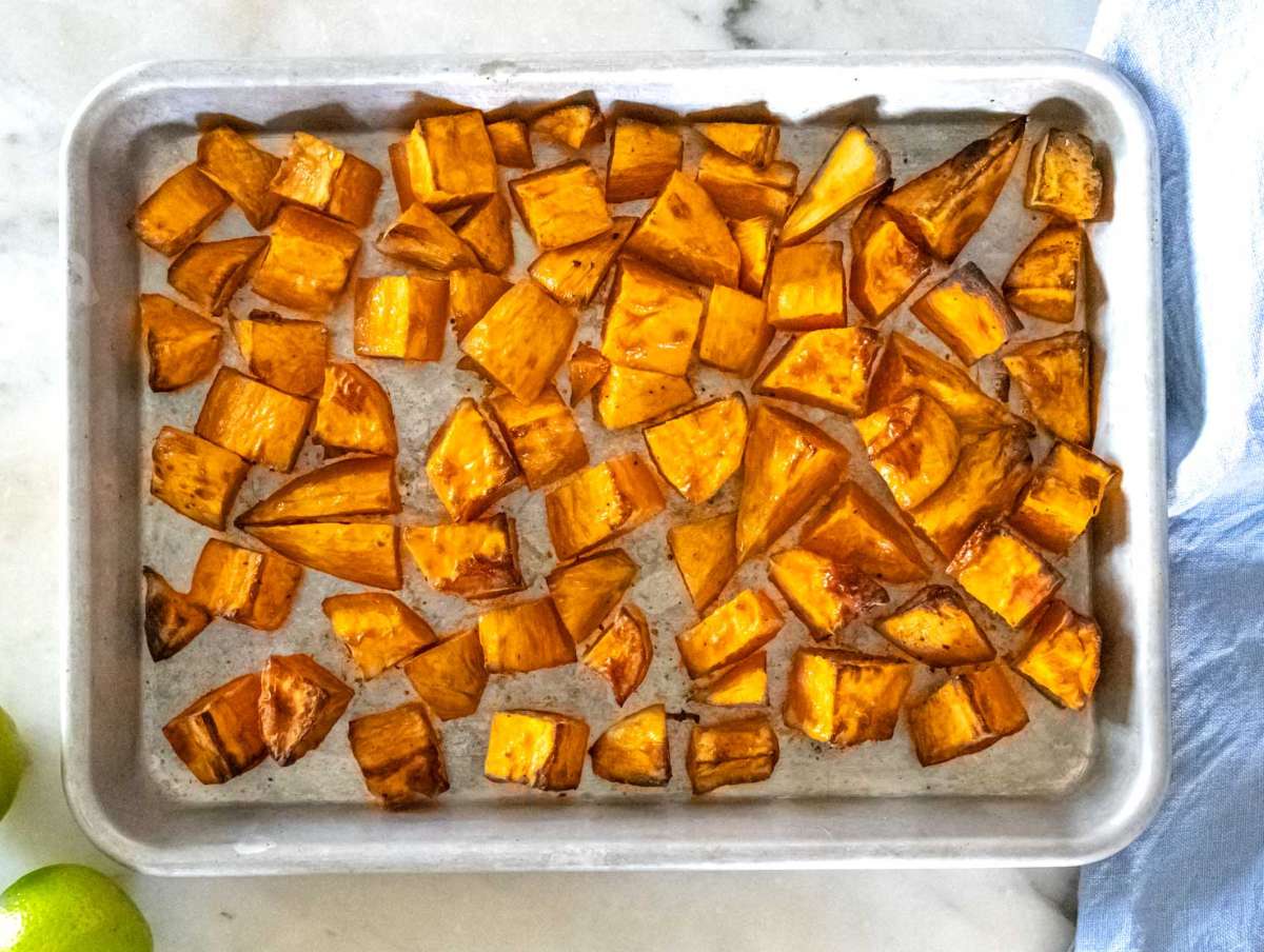 Step 1 Diced sweet potatoes on baking sheet roasted with olive oil, salt, and black pepper.