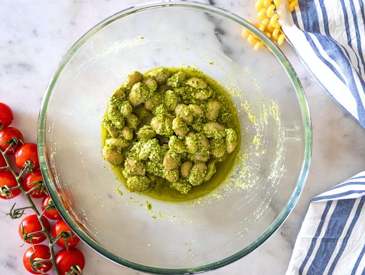 Step 1 Marinating butter beans with pesto lemon zest and juice in a mixing bowl.
