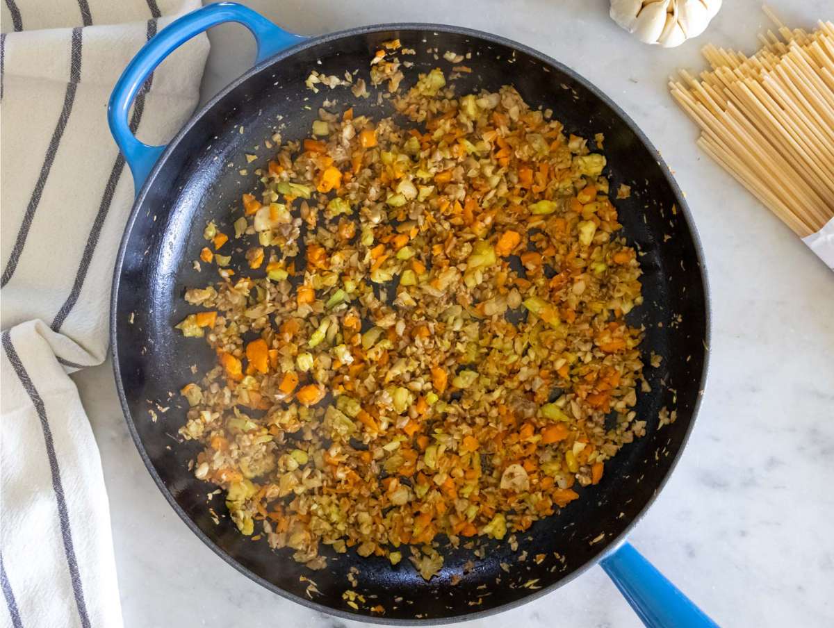 Step 1 Sautéed vegetables mushrooms rosemary salt and pepper cooking in a skillet.
