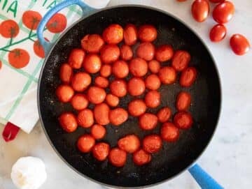 Step 1 Tomatoes blistering in skillet for cherry tomato orzo recipe.