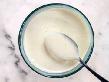 Step 1 Whisking Greek yogurt mayo mustard honey and vinegar for creamy salad dressing.