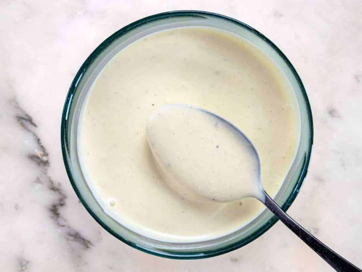 Step 1 Whisking Greek yogurt mayo mustard honey and vinegar for creamy salad dressing.