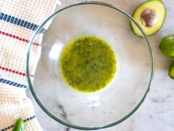 Step 1 Whisking dressing for Cowboy Caviar with olive oil cilantro lime honey and mustard.
