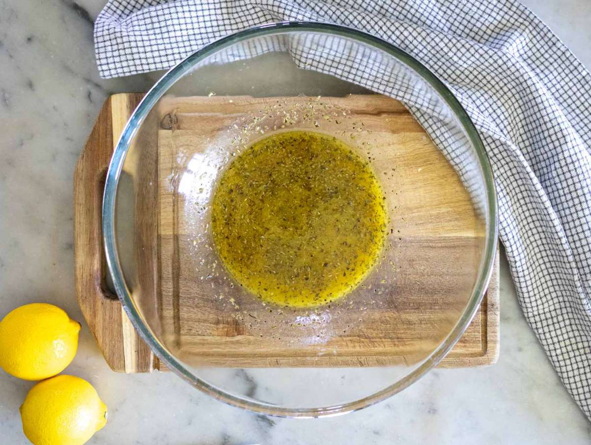 Step 1 dressing for high protein bean salad in a large glass mixing bowl.
