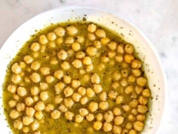 Step 2 Chickpeas marinating in olive oil vinegar dressing for chickpea cucumber salad.
