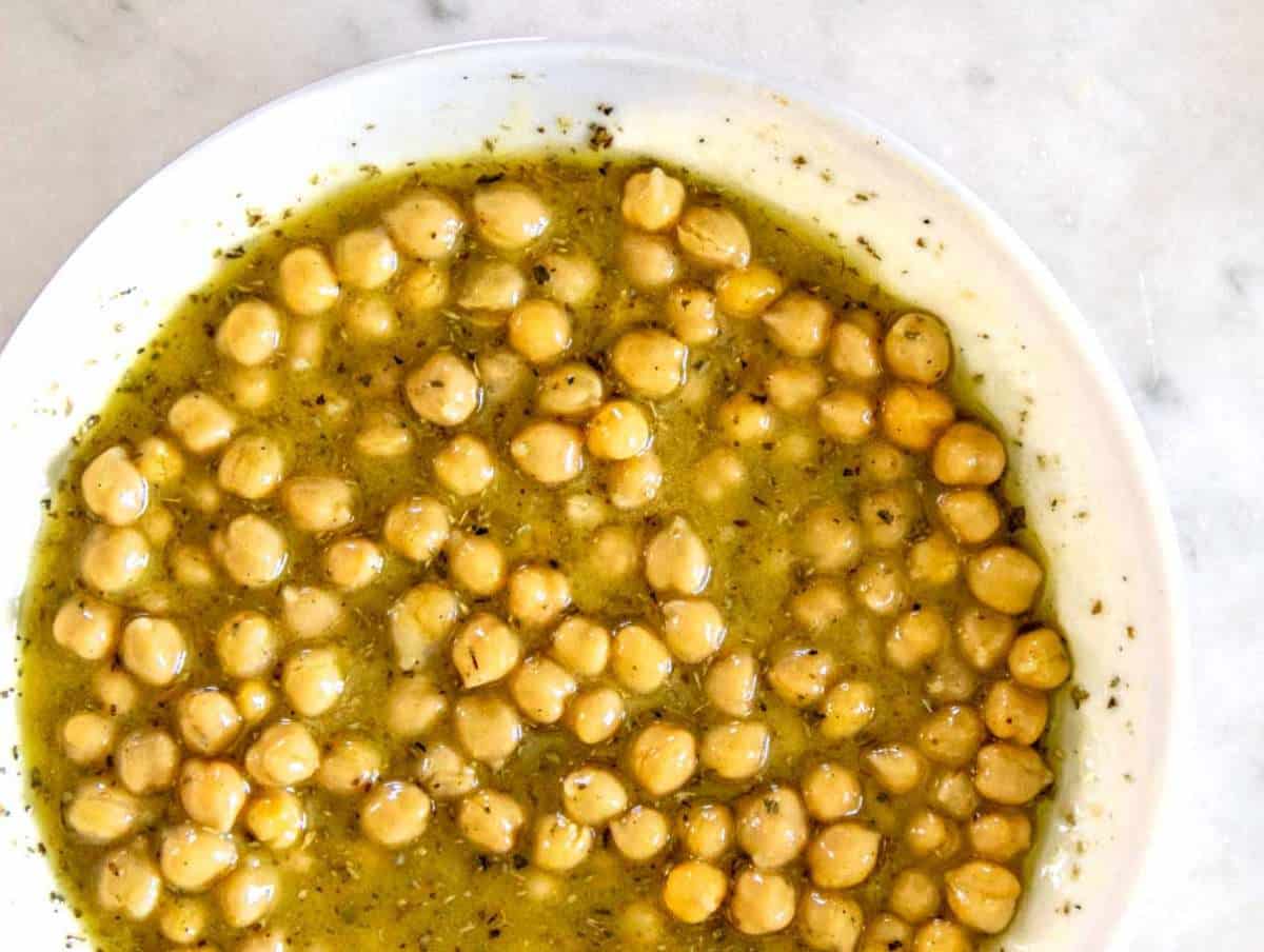 Step 2 Chickpeas marinating in olive oil vinegar dressing for chickpea cucumber salad.