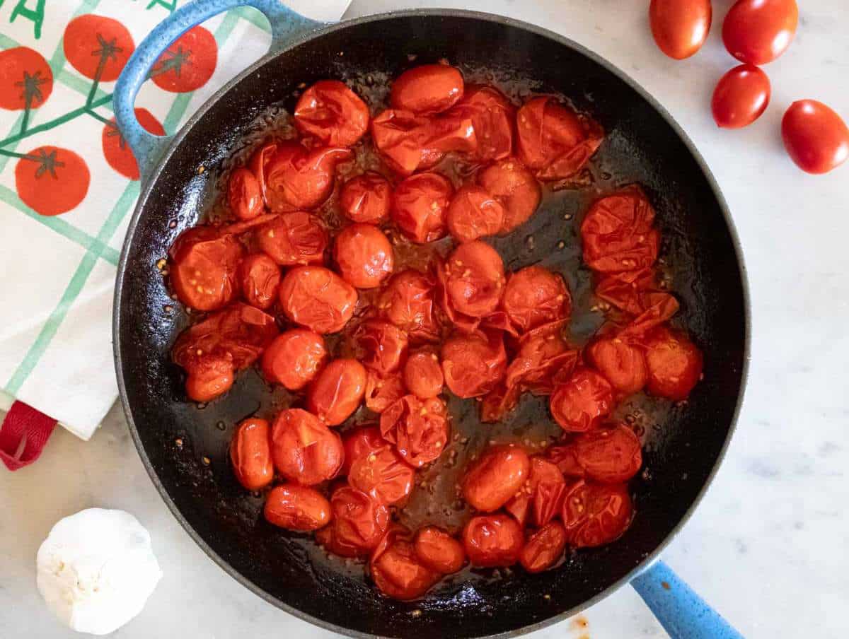 Step 2 Garlic herbs and seasoning cooking with tomatoes.