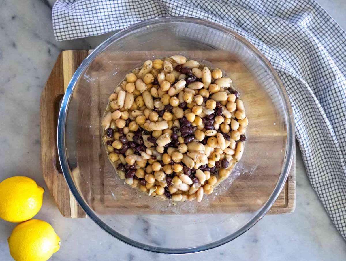 Step 2 Marinating beans in dressing for high protein bean salad before adding vegetables.