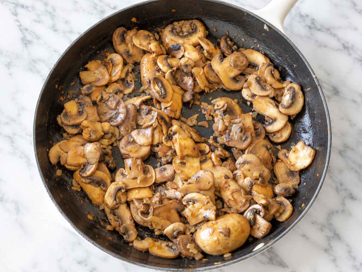 Step 2 Sliced mushrooms cooking with onion and garlic until soft and browned.
