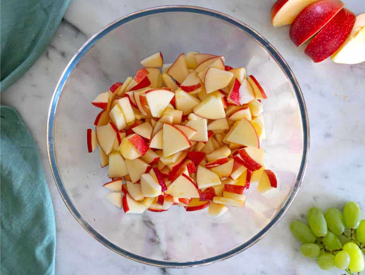Step 2 Tossing diced apples with lemon juice to keep them fresh and crisp.