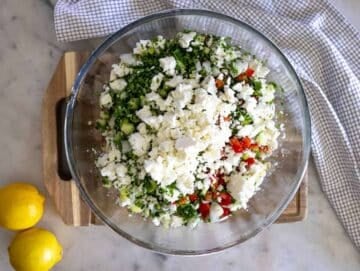 Step 3 Chopped vegetables and feta being added to high protein bean salad mixture.