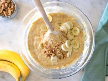 Step 3 Folding flour baking soda baking powder, walnuts, and an extra banana into wet banana bread batter.