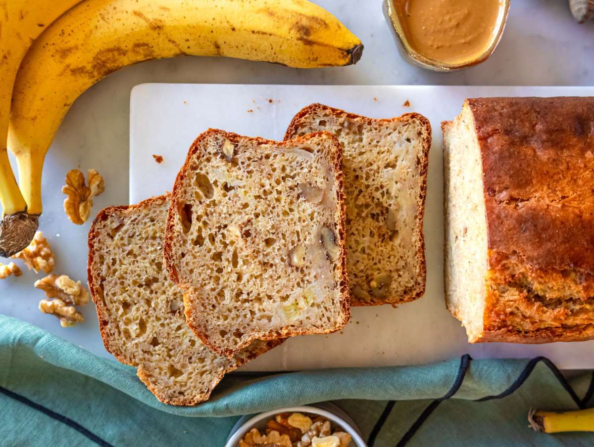 Step 4 Baked protein banana bread sliced on a marble cutting board ready for a snack.