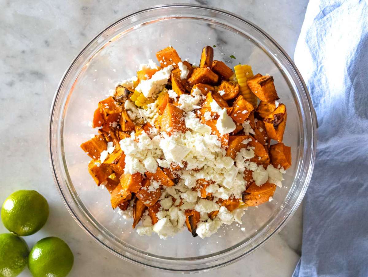 Step 4 Corn bell pepper red onion jalapeños feta and roasted sweet potatoes added to marinated black beans.