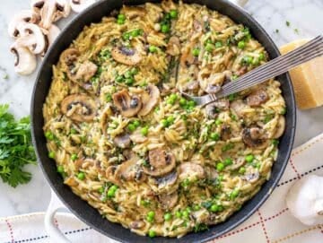 Step 4 Creamy mushroom orzo finished with peas, Parmesan, parsley, lemon zest, and black pepper.