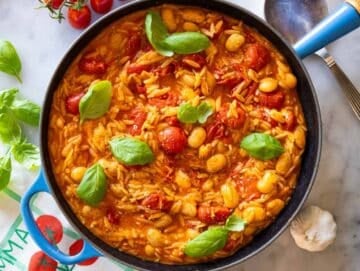 Step 4 Parmesan lemon zest and basil added to finished cherry tomato orzo in skillet.