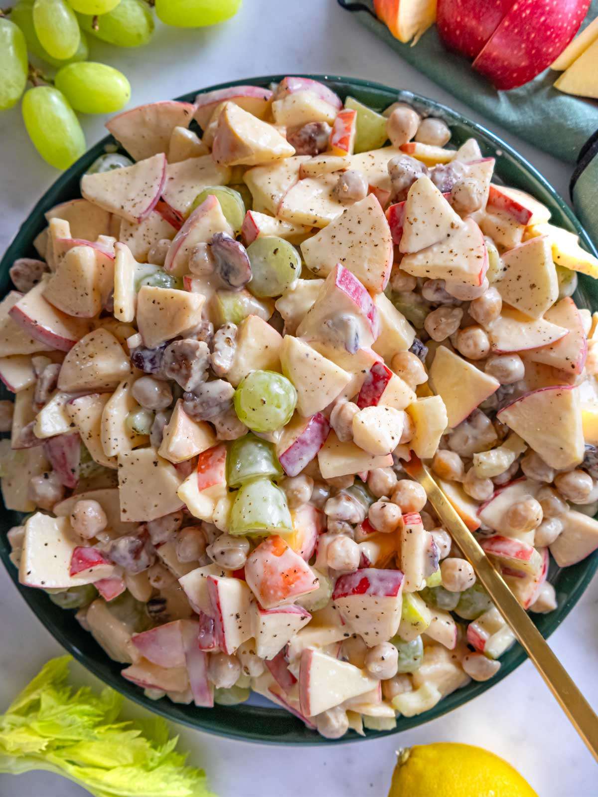 Top down view of apple chickpea salad served in a large mixing bowl.