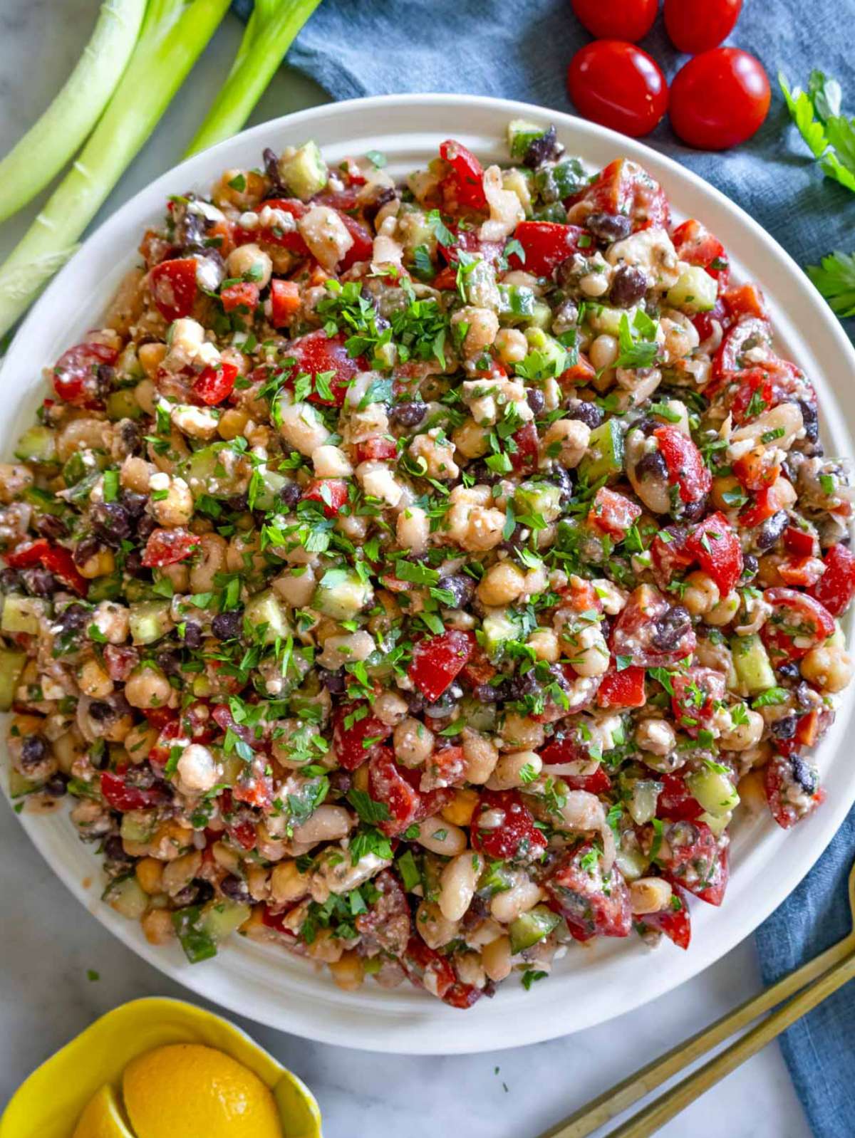 Top down view of high protein bean salad in a white serving bowl.