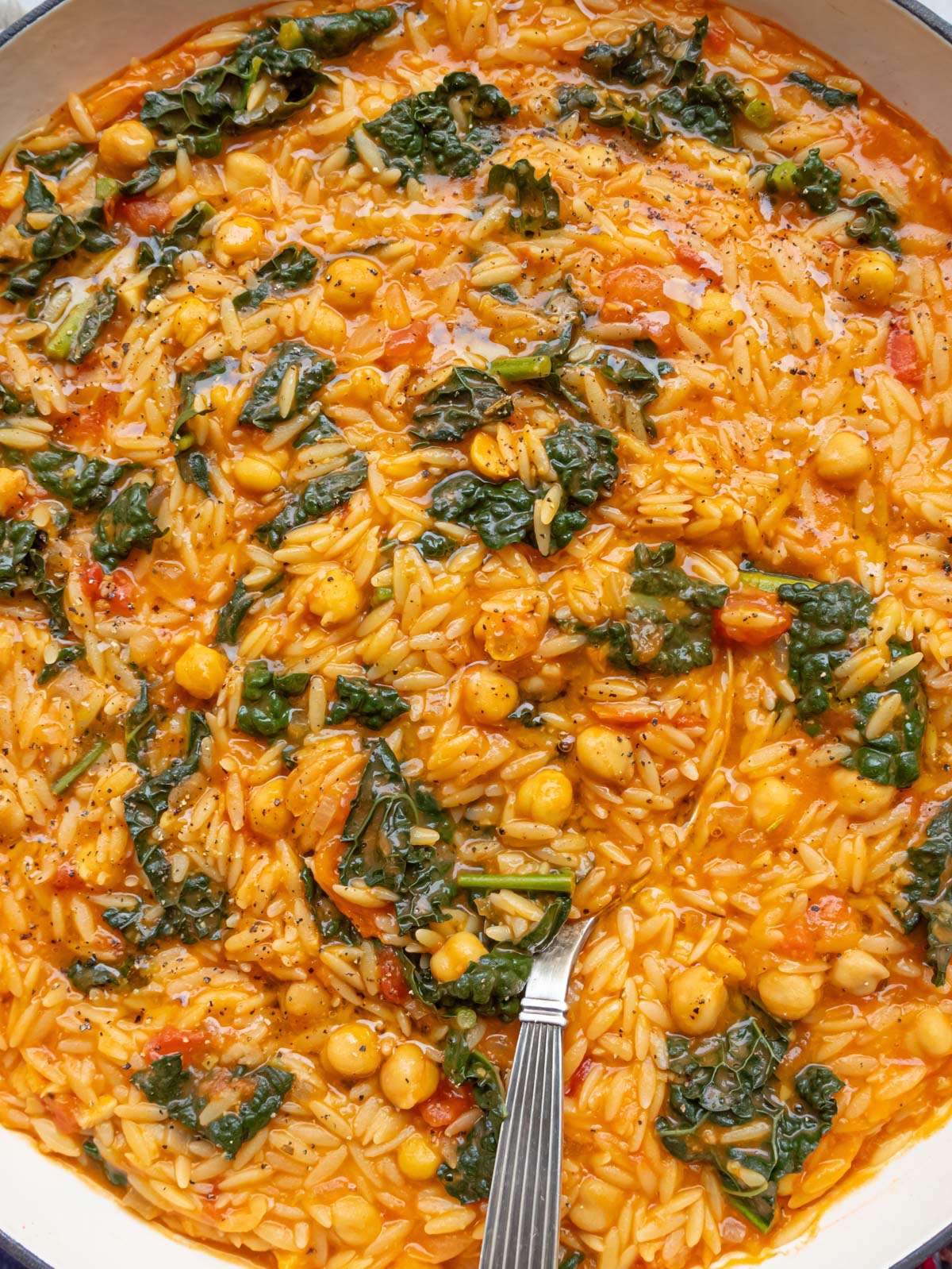 Creamy Tuscan Orzo with Chickpeas and Kale served from the skillet.