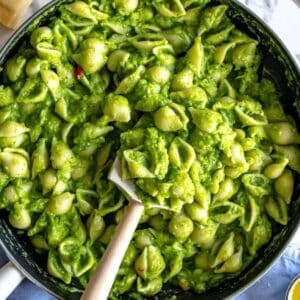 Creamy smashed broccoli pasta serve from a cast iron skillet.