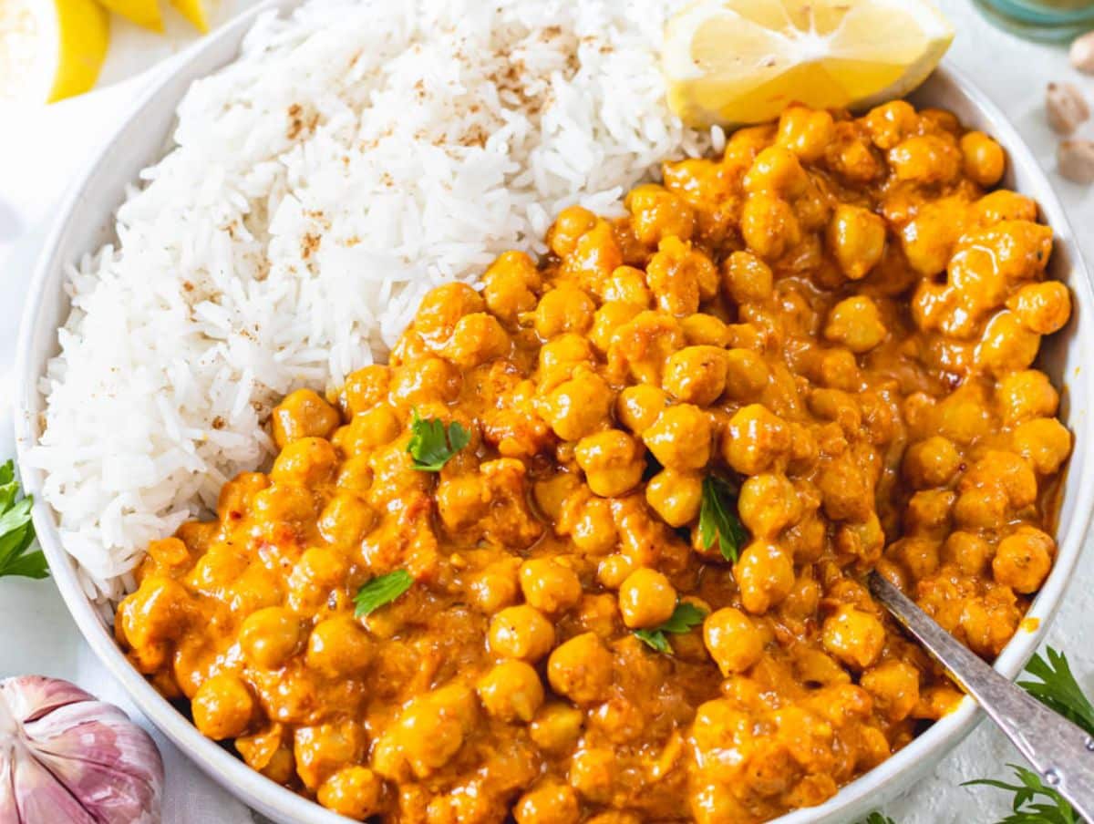 Easy coconut curry recipe with chickpeas creamy high fiber meal in white serving bowl.