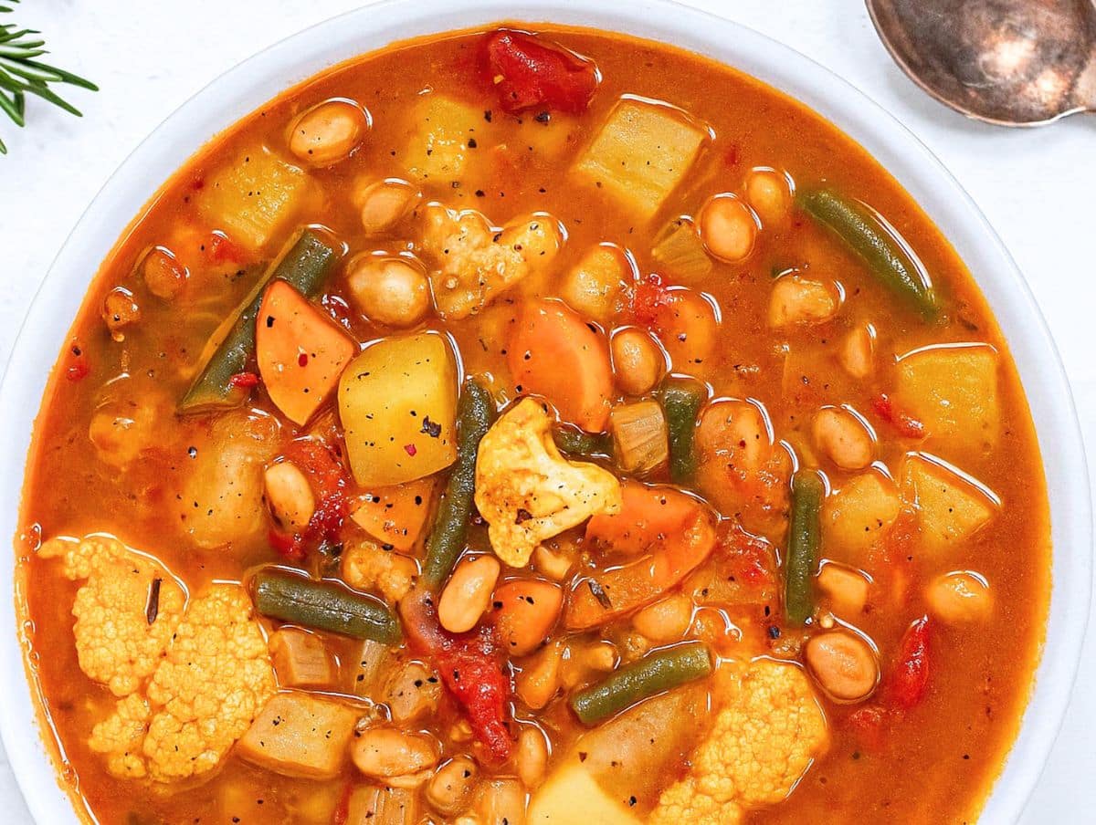 Healthy vegetable soup served in rustic bowl with bread perfect for easy weeknight dinner