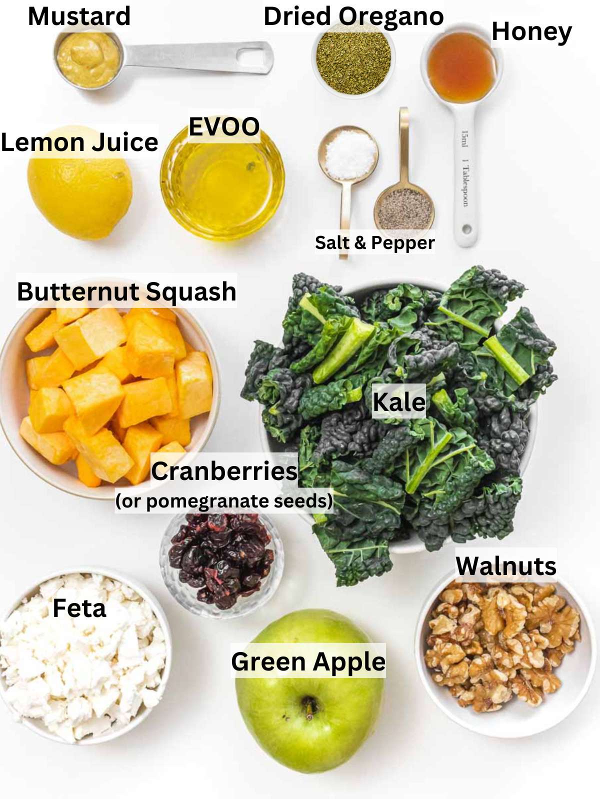 Ingredients for butternut squash kale salad with apple walnuts feta and homemade dressing arranged neatly.