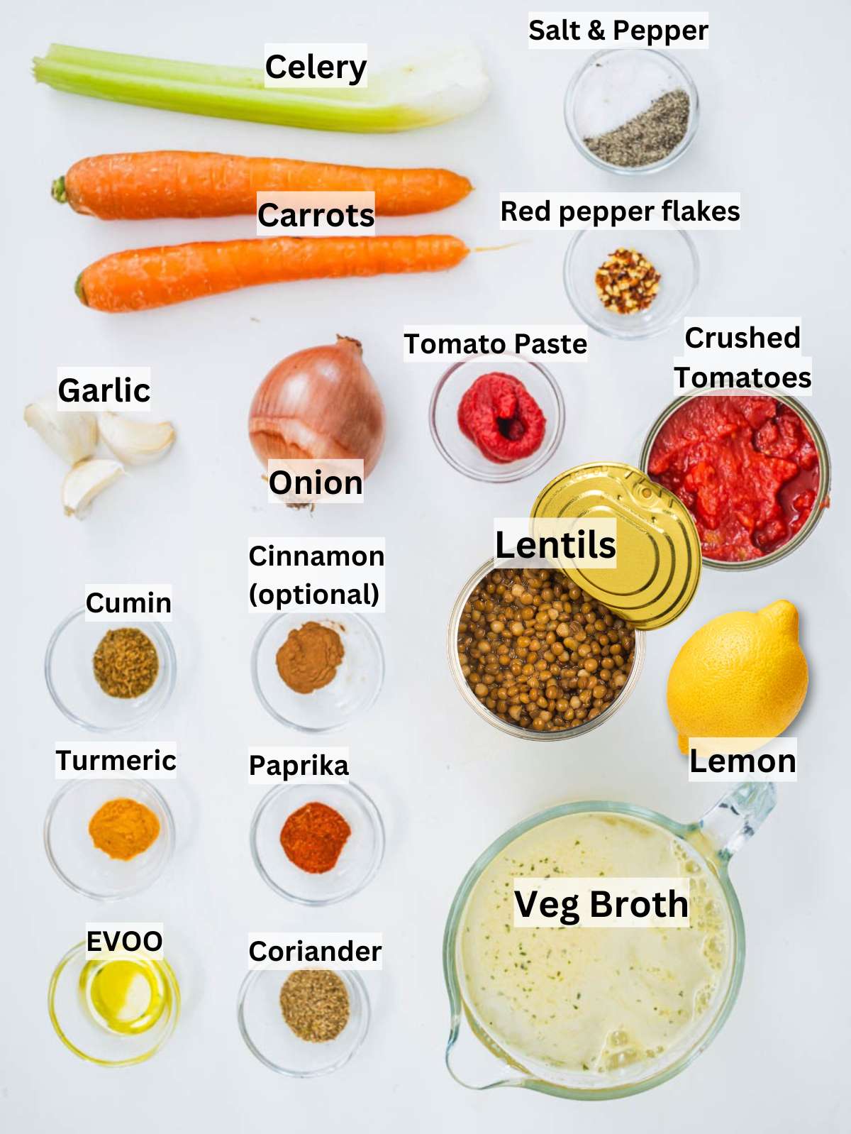Ingredients for spiced lentil soup arranged on a wooden table with fresh herbs and spices.