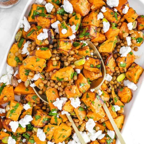 Mediterranean healthy lentil sweet potato salad served in a white bowl with feta.