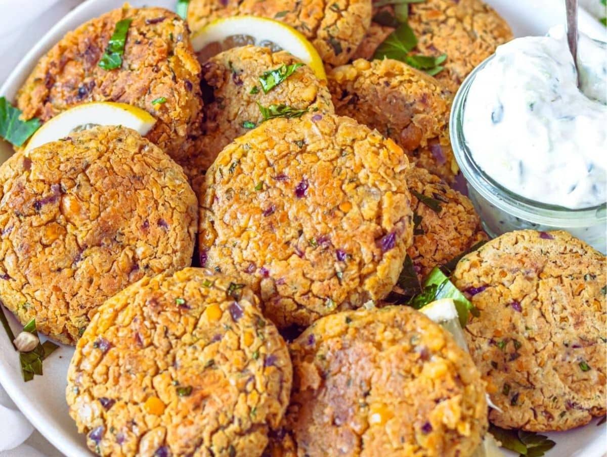 Mediterranean style Greek chickpea patties arranged beautifully with lemon and fresh parsley.