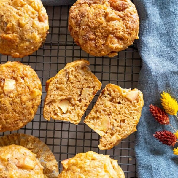 Protein apple muffins with greek yogurt and peanut butter on a cooling rack.