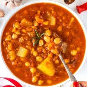 Rustic Mediterranean chickpea soup in a white bowl ready for a cozy healthy dinner.