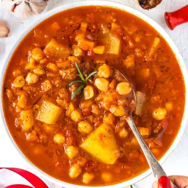 Rustic Mediterranean chickpea soup in a white bowl ready for a cozy healthy dinner.