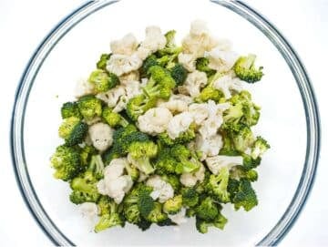 Step 1 Chopped broccoli and cauliflower florets in mixing bowl for healthy broccoli cauliflower salad.