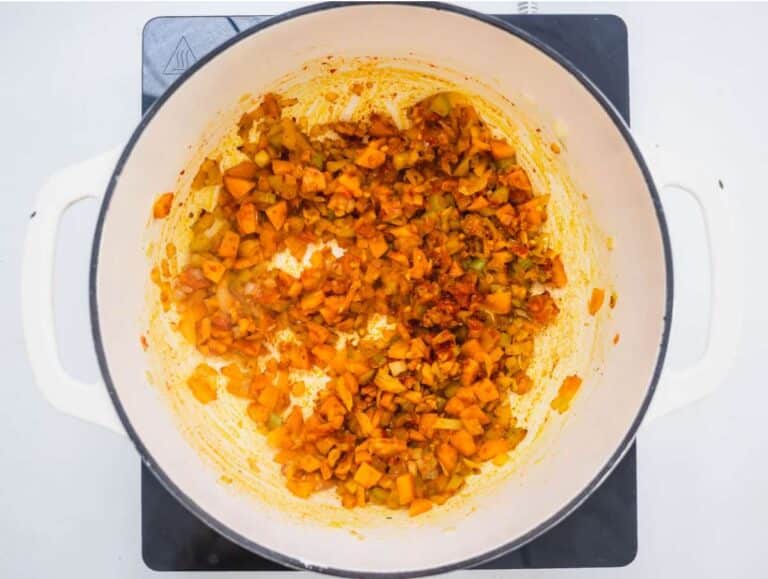 Step 1 Chopped onion carrot and celery sautéing in olive oil with garlic tomato paste and spices.