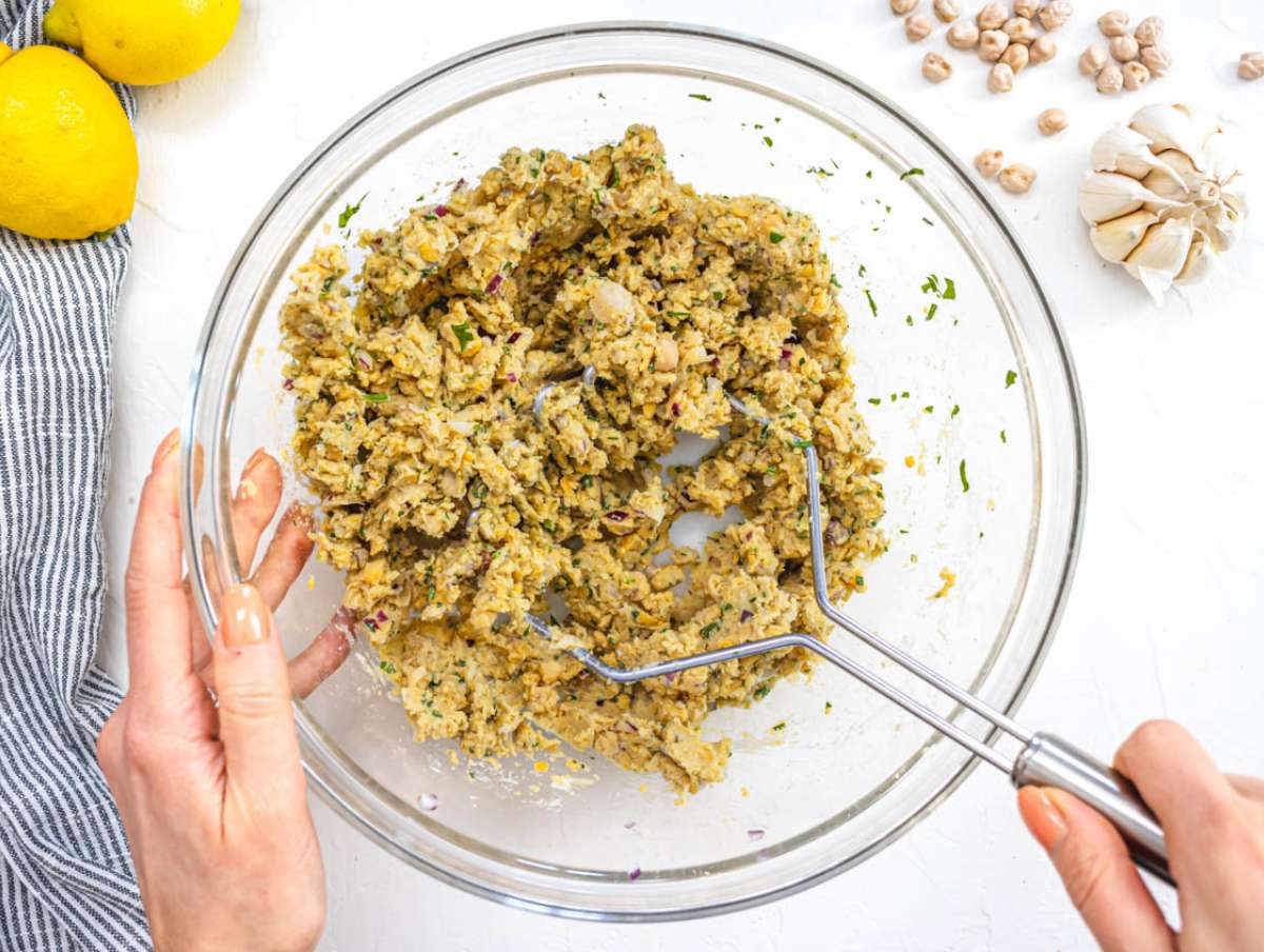Step 1 Mixing chickpeas onion garlic herbs and spices in a large bowl for patties.