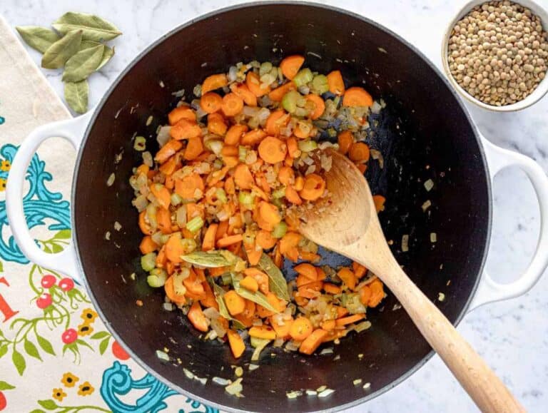 Step 1 Onion celery carrot and garlic sautéing gently in pot with olive oil and oregano.