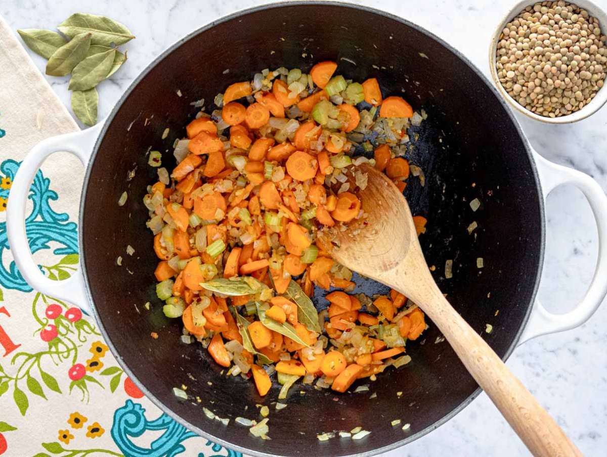 Step 1 Onion celery carrot and garlic sautéing gently in pot with olive oil and oregano.