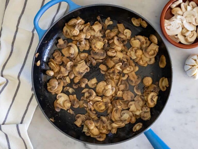 Step 1 Sautéing mushrooms and garlic in olive oil until golden in a large skillet.