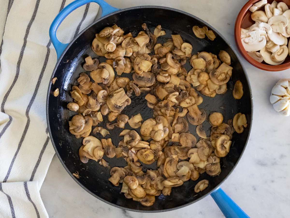 Step 1 Sautéing mushrooms and garlic in olive oil until golden in a large skillet.