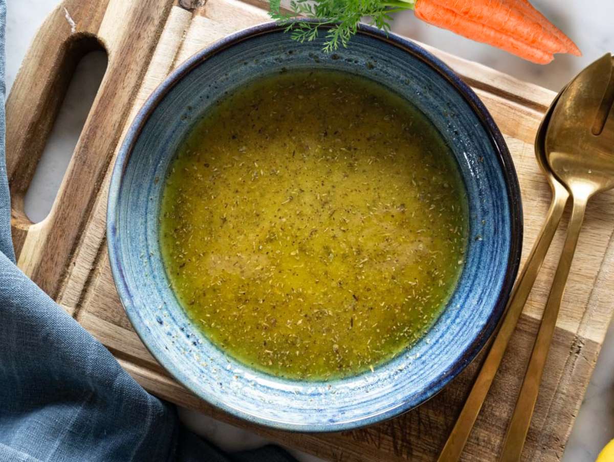 Step 1 Whisking olive oil vinegar mustard honey and oregano into creamy honey mustard dressing.