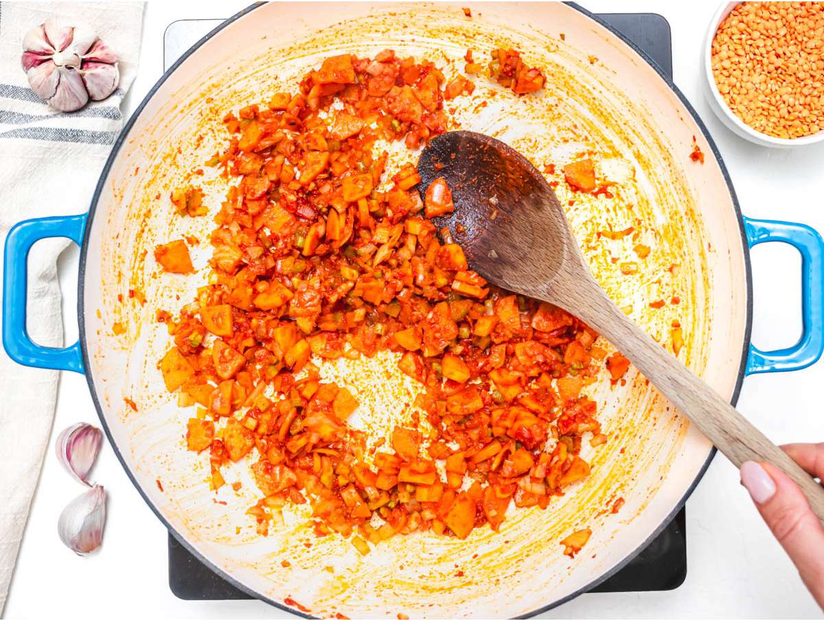 Step 1 cooking onion carrot celery and garlic in olive oil with tomato paste and cumin.