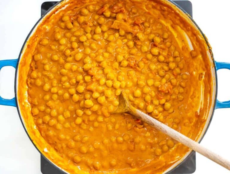 Step 2 Add chickpeas tomatoes coconut milk and stock simmer until thick and creamy curry forms.
