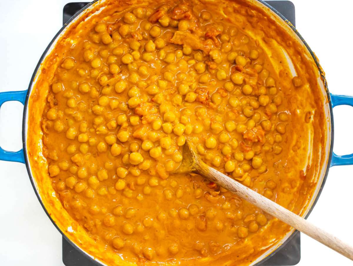 Step 2 Add chickpeas tomatoes coconut milk and stock simmer until thick and creamy curry forms.