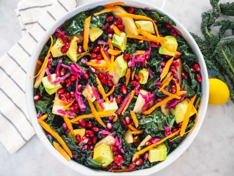 Step 2 Adding apple carrot avocado cabbage and feta to massaged kale salad base.