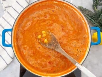 Step 2 Chickpeas tomatoes and broth simmering in a skillet.